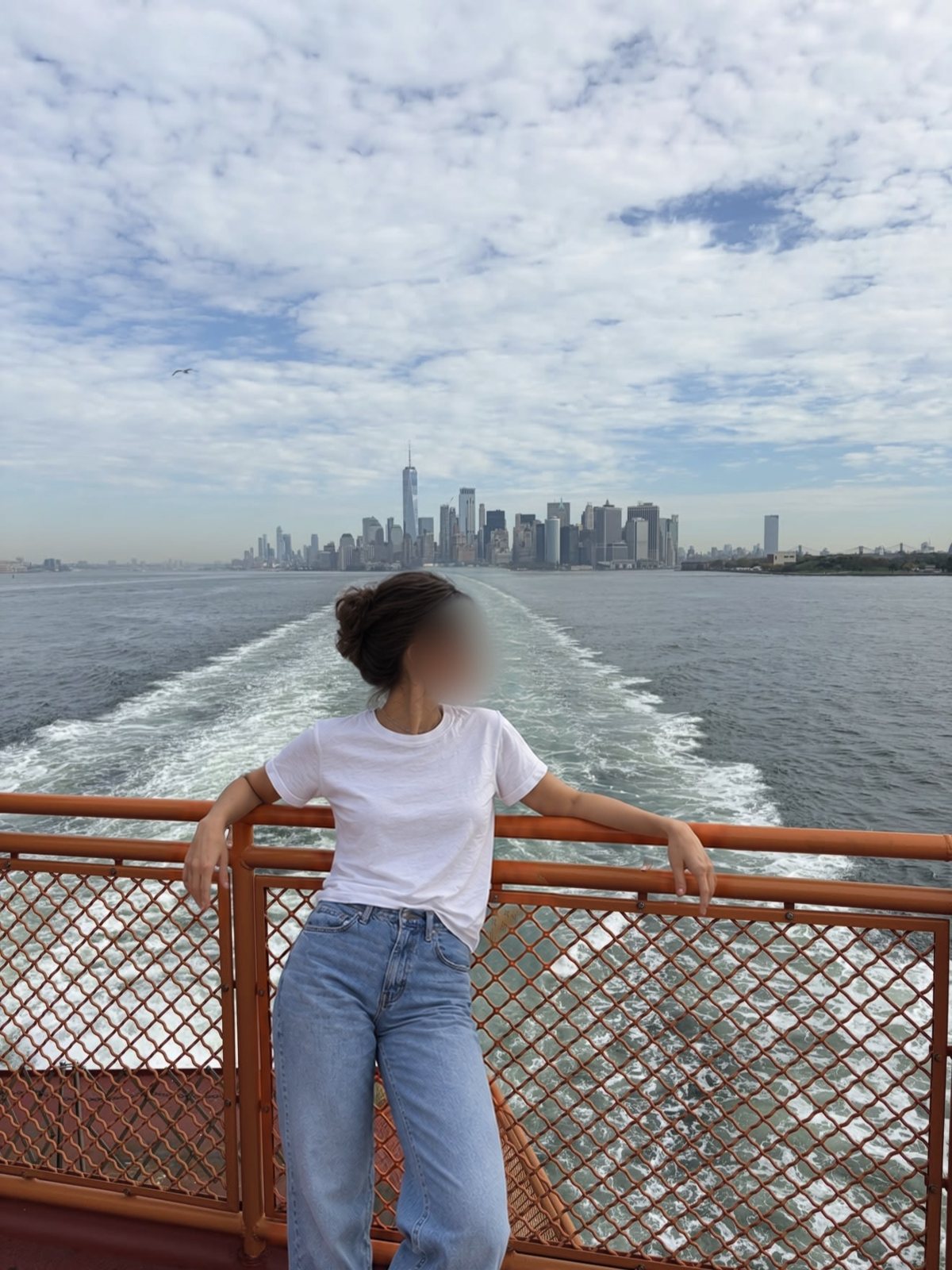 Medea on the ferry, Manhattan behind her